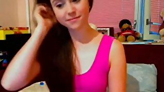 Brunette teen angel takes off her pink dress on webcam