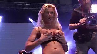 busty german milf toying on public stage