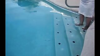 Corpulent granny in nylons plays in the pool