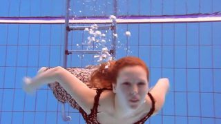 Redheaded Katka playing underwater