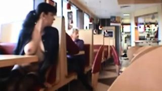 Dark haired girl flashing boobs in public restaurant