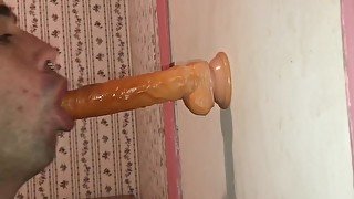 Chocking and sucking on a dildo