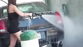 Memorable gal in a too-short black dress is filmed by a voyeur while washing her vehicle.