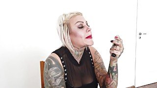 Tattooed blonde milf lipsticks her lips