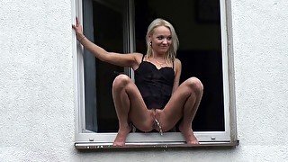 Got2Pee - Blonde babe squats in the window to piss over the edge