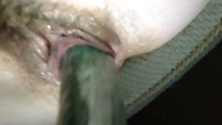 Horny and slutty wife poking her hairy vagina with cucumber