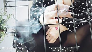 SMOKING TEASE WHILE SLAVE IS LOCKED IN CAGE