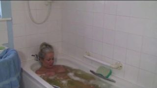 Mature slut washing her old pussy