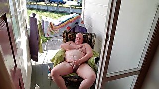 Fat man masturbates by a public road.