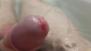 Extreme closeup uncut pissing cock