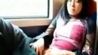 Asian milf rubs her clit on a train.