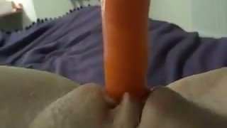 Perverted wife of mine pushes carrot right in her hungry shaved twat