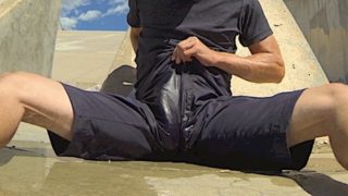 Pissing black athletic shorts in public and cumming inside them