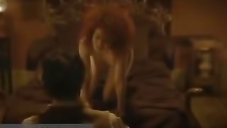 Sexy redhead kisses bearded guy while seducing him in bed.