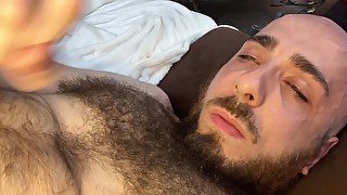 Very hairy bald guy with blue eyes tries to cum in his own mouth but only makes it to his chest