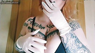 Girl smokes a cigarette and plays with her tits with gloves