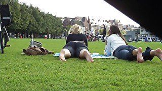 Two Hot Young Unsuspecting Ladies Get Their Cute Bare Feet Filmed On The Grass