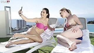 Two libidinous girlfriends are dildo fucking each others pussies by the poolside