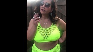 Curvy milf smoking outdoors