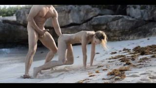 Extreme art sex of sleek couple on beach