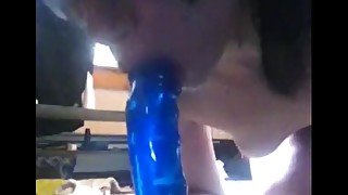 Sucking on "big blue" dildo