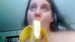 White trash whore on webcam chews banana and shows it