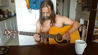 Naked guy playing guitar