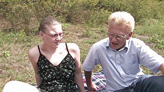 Lovely babe is pleasing an older guy's cock outdoors