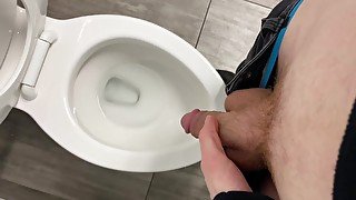 Pissing in a public toilet.