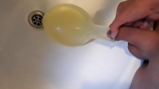 young german twink pissing in condom till its completely full and blown up like a baloon and jerking