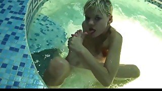 Cute blonde model playing in the pool