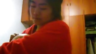 Asian girl with big boobs changes clothes in her bedroom