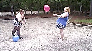 BBW gals play volley ball with balloons