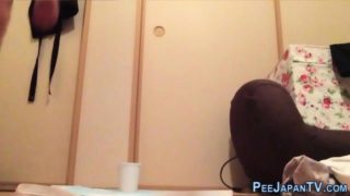 Asian teen pissing cup