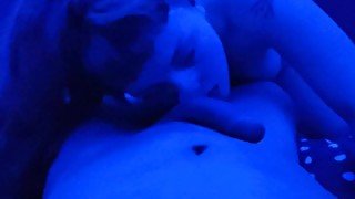 Petite ginger bitch sucking dick under blue light