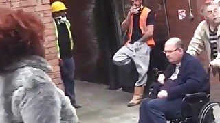 Stranger worker with a hand in his pants tugging on the street