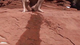 Skinny Brunette Pees on the Rocks