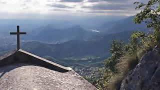 Cute twink boy enjoys the sunset in the mountains