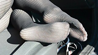 Sexy legs in tights posing in the car