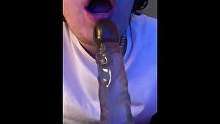 Sucking Tall boy dildo with spit.