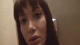 Lewd brunette shemale exposes her big boobies in the bathroom