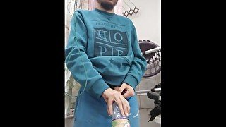 Boy pissing on A bottle Just to pour the Pee Out later