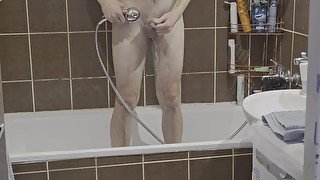 Amateur young man showering himself