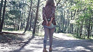 Handcuffed girl walks in the forest with the vibrator inside her diaper