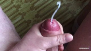 Sweet precum drop flows down a hard cock