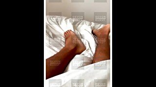 Boys feet waking up in white bedding