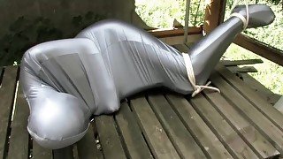 Bondaged and cocooned slave girl escapes from the mystery garden - Full spandex encasement fetish