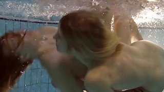 Two hot lesbos swimming in the pool