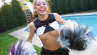 A cute cheerleader flashes her tits while in her uniform