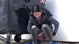 Nasty dark haired slut pisses near trash box outdoors